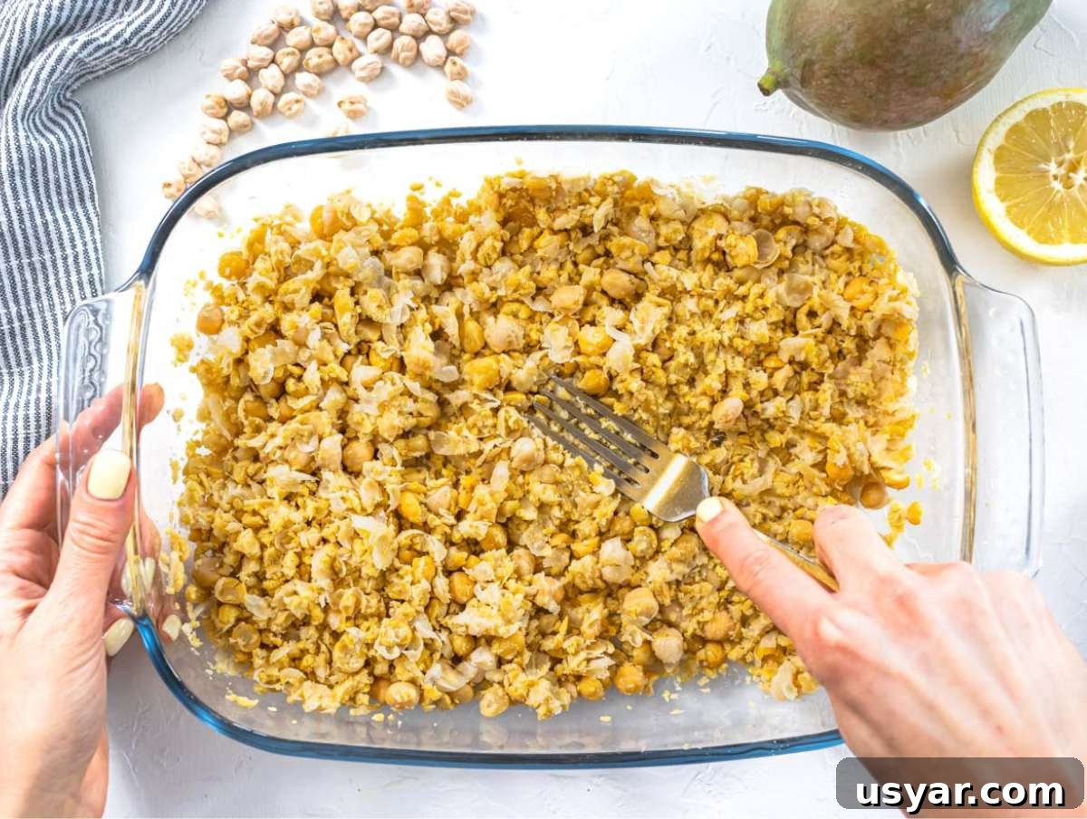 Step 2 Mashing the chickpeas with a fork.