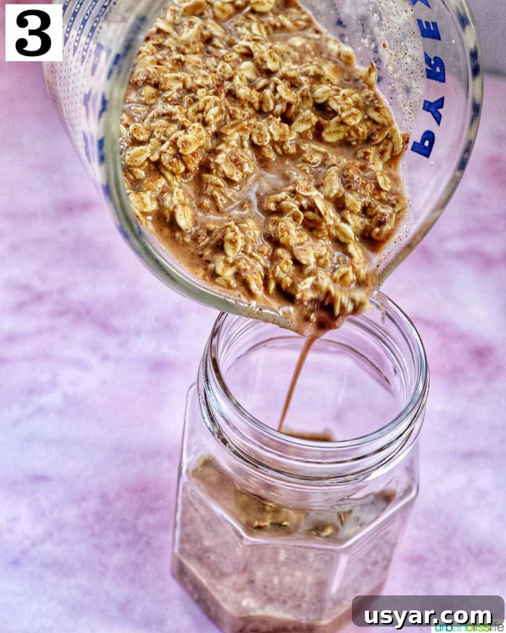Creamy Biscoff Overnight Oats Recipe 7 pouring Biscoff overnight oats ingredients into a mason jar.
