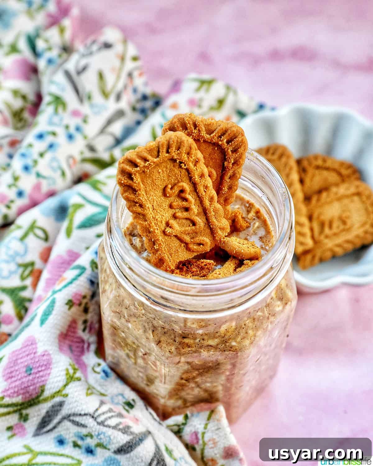 Creamy Biscoff Overnight Oats Recipe 8 Biscoff overnight oats in a jar with crumbled Biscoff cookies on top.