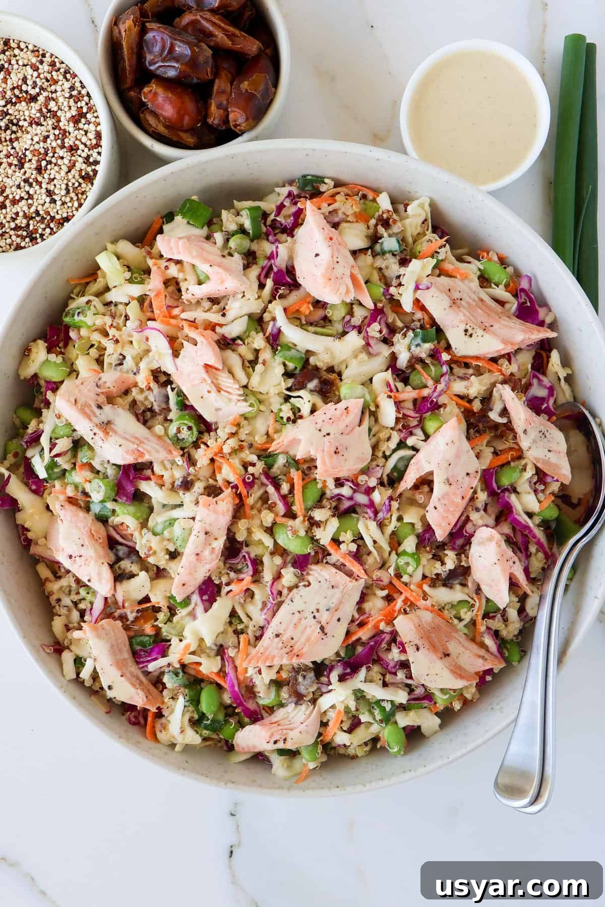 Smoked Trout and Edamame Salad with Lemon Dressing 2 Smoked trout salad in large serving bowl with spoons.