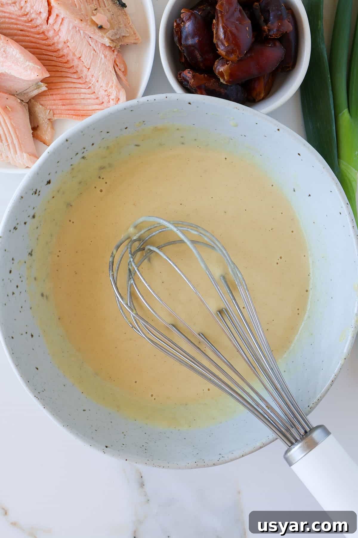 Smoked Trout and Edamame Salad with Lemon Dressing 5 Tahini dressing in a bowl with a whisk.