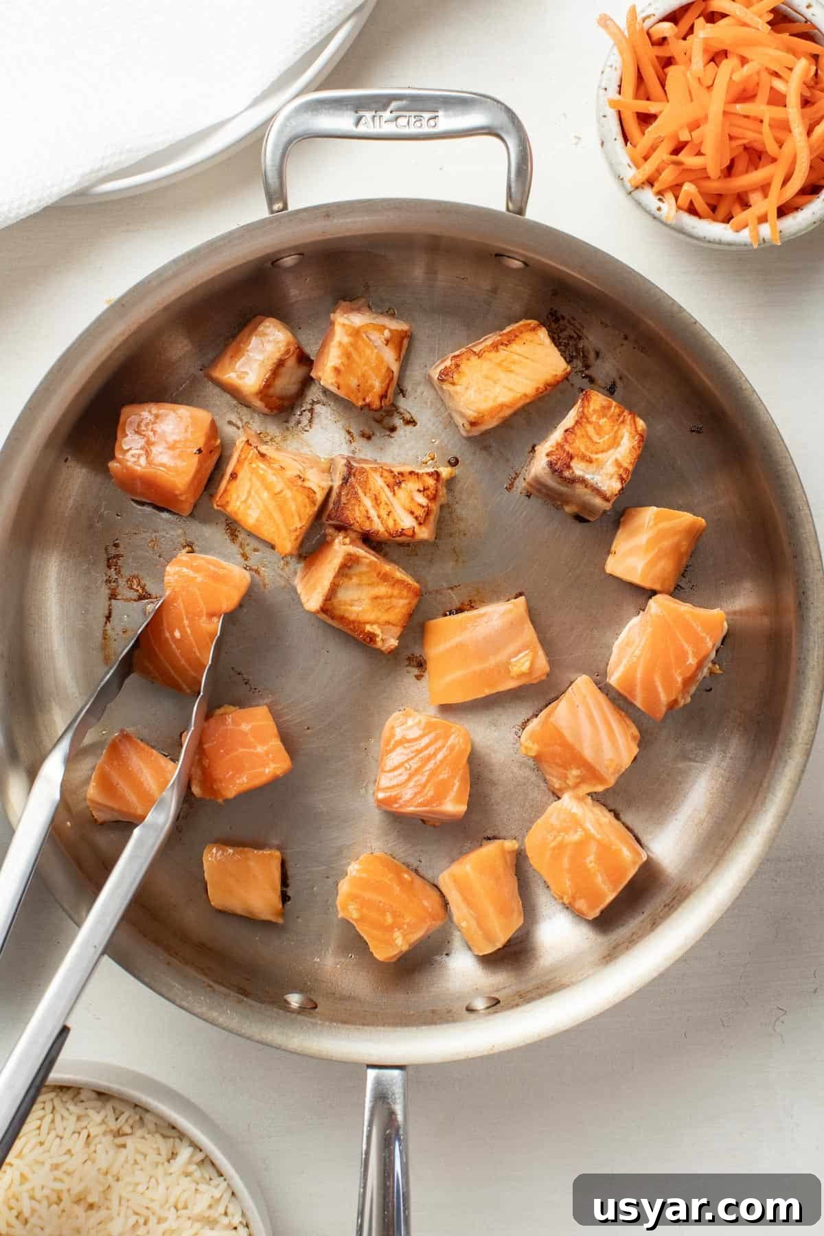 Spicy Mayo Salmon Rice Bowl 6 Searing salmon pieces in a stainless steel pan.