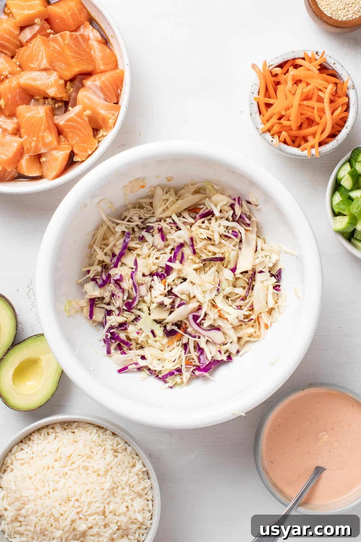 Spicy Mayo Salmon Rice Bowl 7 Slaw tossed in vinegar and coconut aminos in a small white bowl.