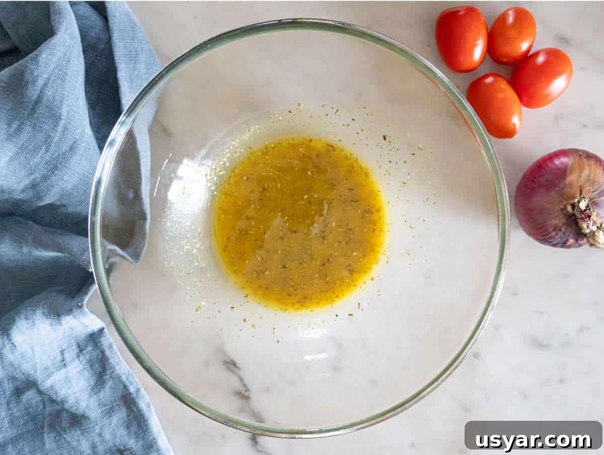 Greek Lentil Salad with Tangy Lemon-Herb Dressing 5 Step 1 Whisking olive oil vinegar mustard honey and oregano to make dressing for Greek lentil salad.