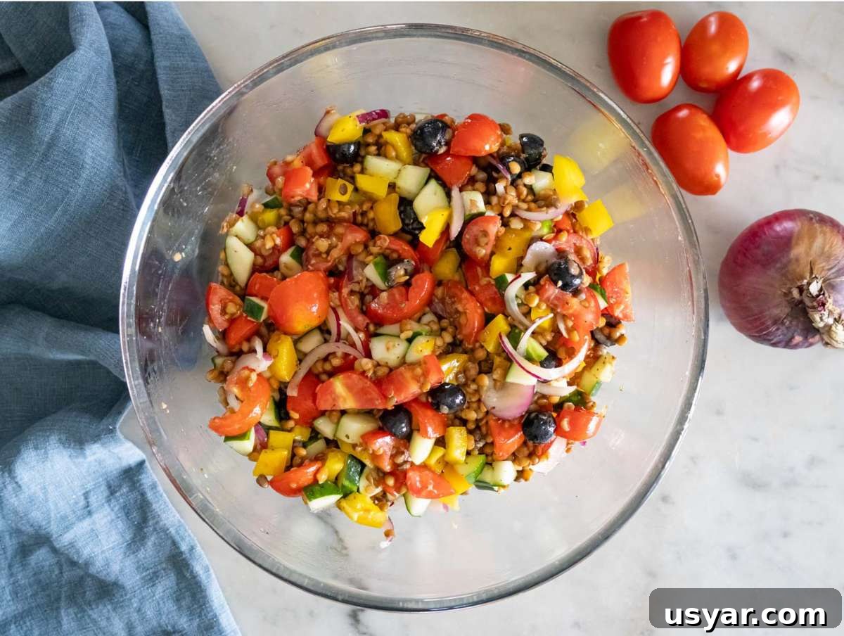 Greek Lentil Salad with Tangy Lemon-Herb Dressing 7 Step 3 Chopped cucumber tomatoes onion olives and bell pepper mixed with marinated lentils.