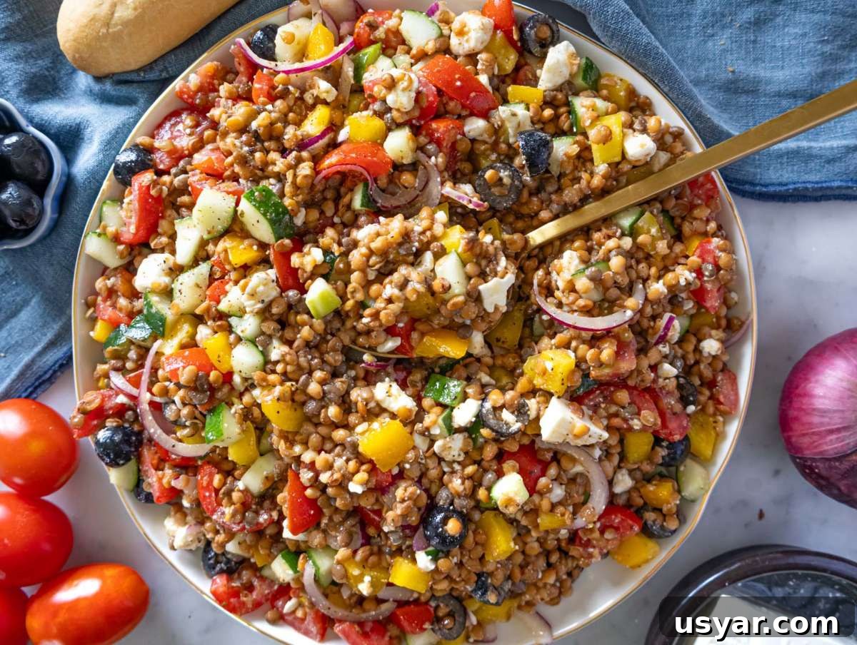 Greek Lentil Salad with Tangy Lemon-Herb Dressing 8 Step 4 Greek lentil salad with feta crumbled in served on a large platter.