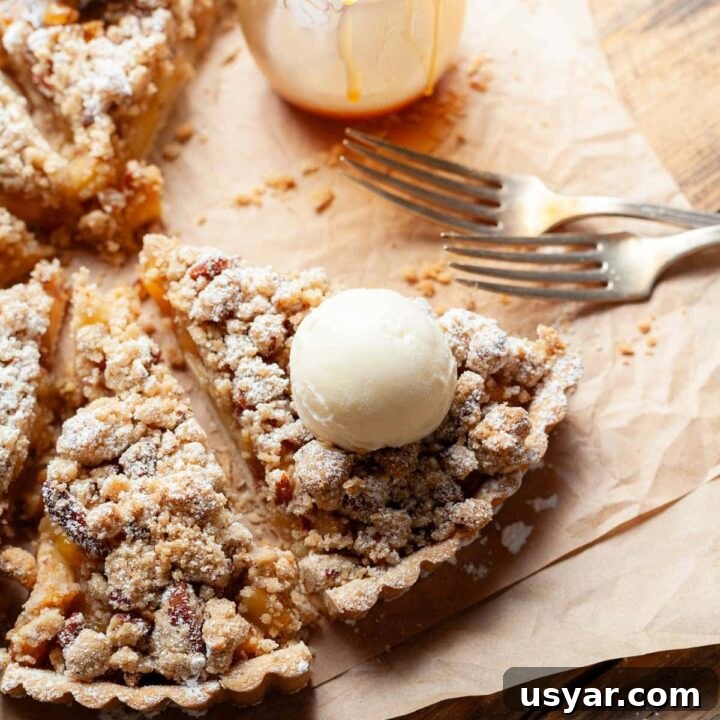 This delicious Gluten-Free Caramel Apple Tart features a buttery crust filled with caramelized apples and topped with a crunchy pecan streusel, making it the perfect dessert for fall gatherings and celebrations like Thanksgiving.
