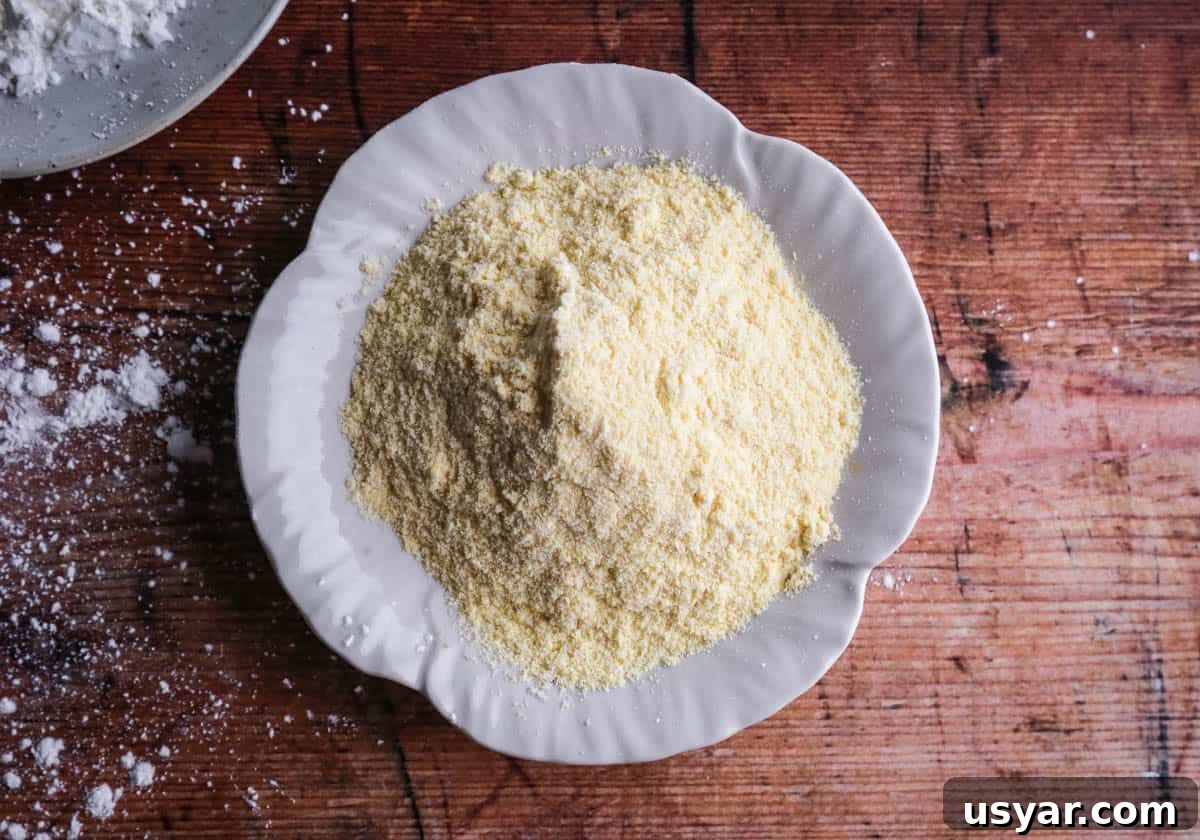 Cornflour vs Cornstarch vs Cornmeal: Key Differences & Uses 9 A plate of fine cornmeal on a table. It's pale yellow with a very fine grain.
