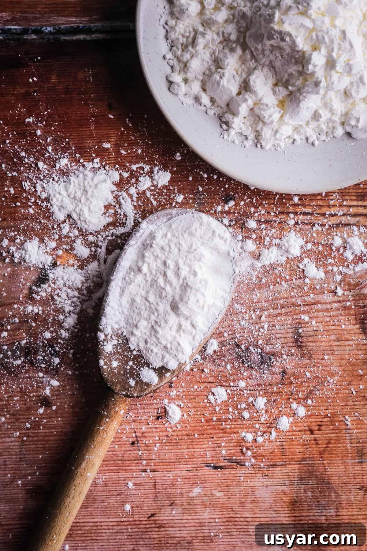 Cornflour vs Cornstarch vs Cornmeal: Key Differences & Uses 3 A spoon of cornflour showing it's white and powdery.