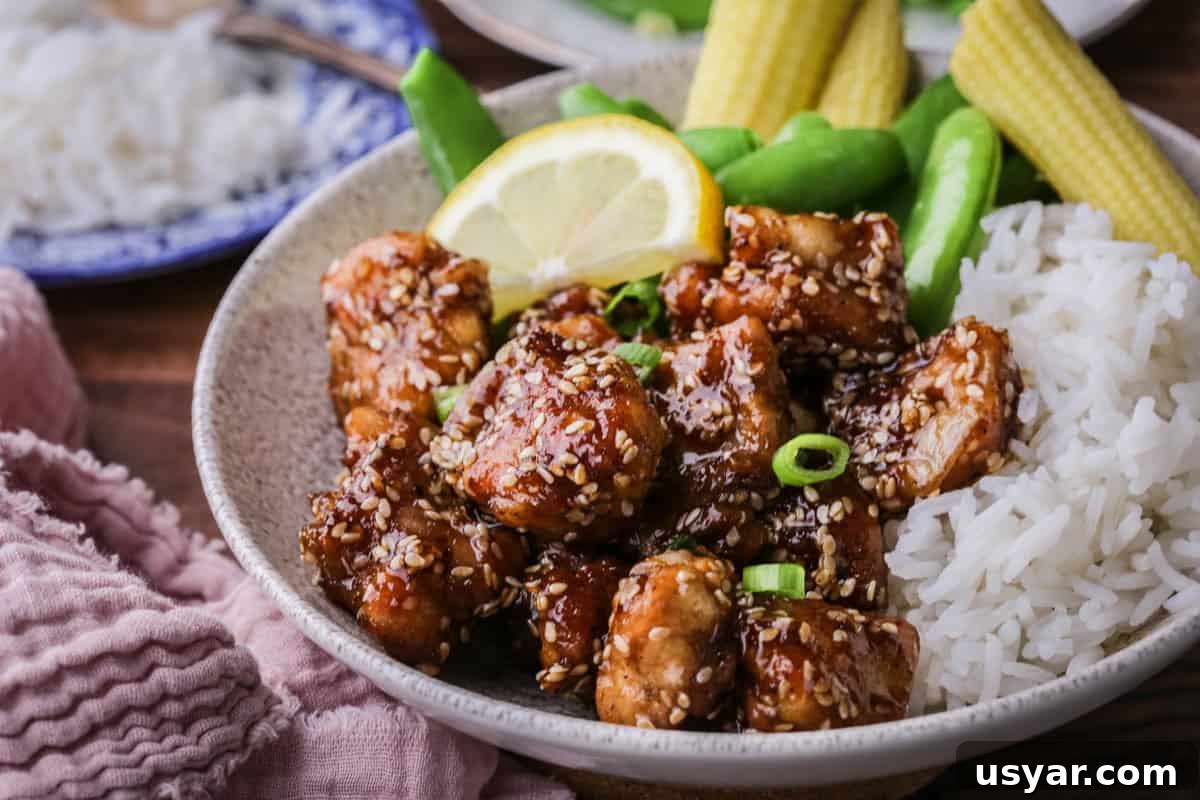 Cornflour vs Cornstarch vs Cornmeal: Key Differences & Uses 7 Sticky Lemon Chicken in a bowl with rice and vegetables.