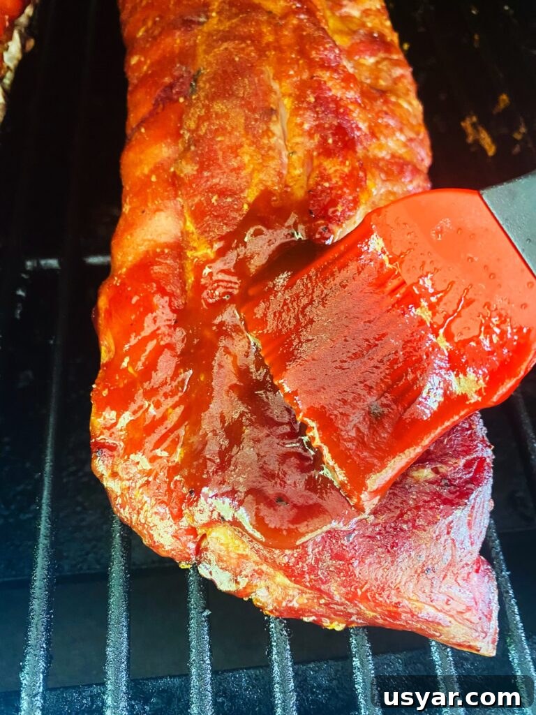 Smoked Ribs with Cherry Coke Glaze 8 brushing Smoked Cherry Coke Glazed Ribs with sauce