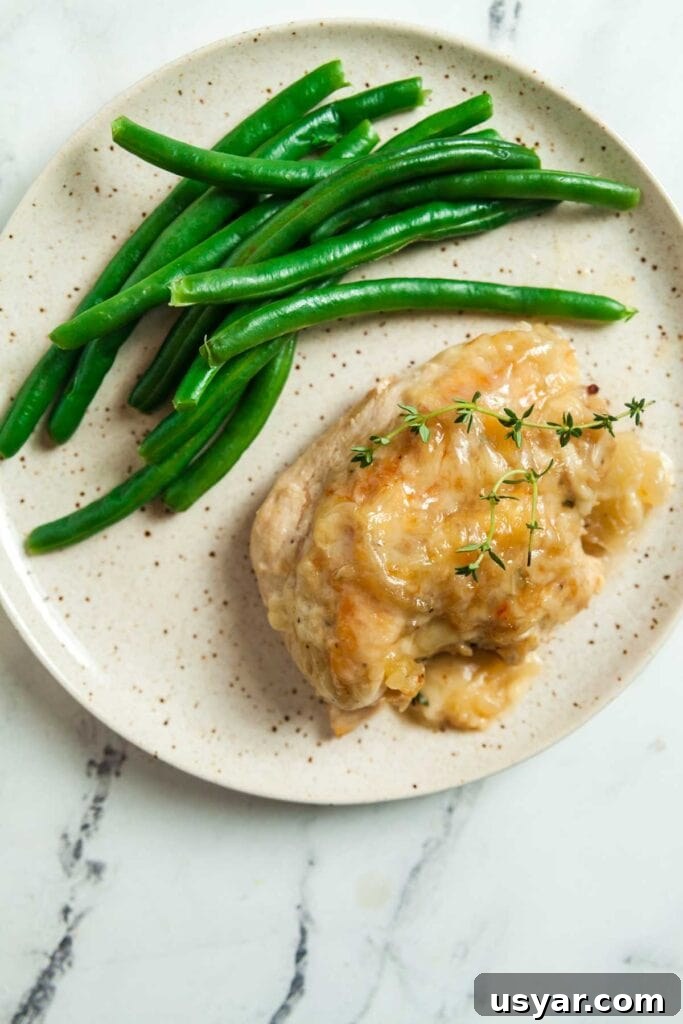 French Onion Skillet Chicken Breasts 6 A plate with skillet French onion chicken and green beans.