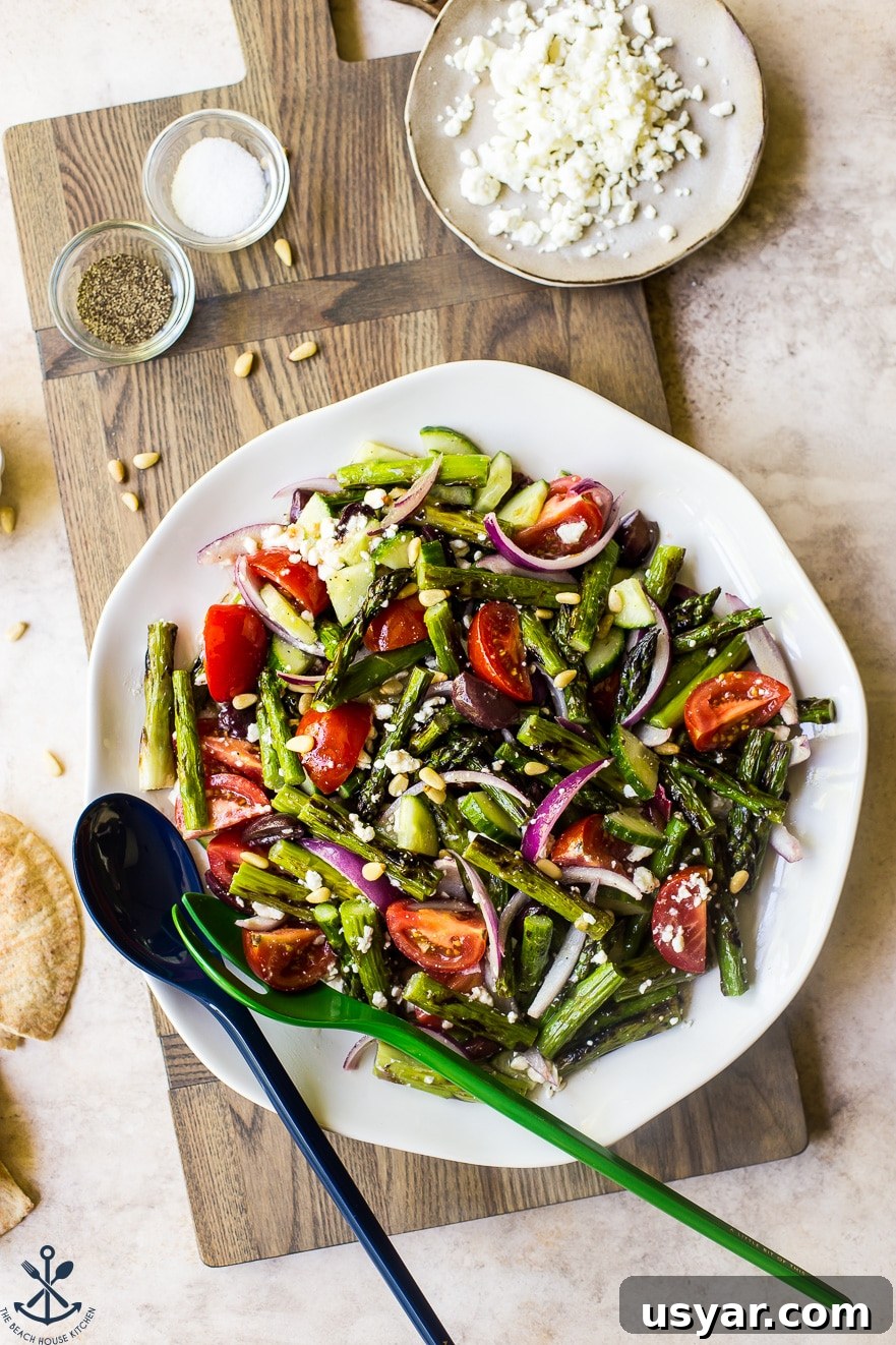 Charred Grilled Asparagus Salad with Lemon Vinaigrette 5 Overhead photo of grilled asparagus salad on a round white plate