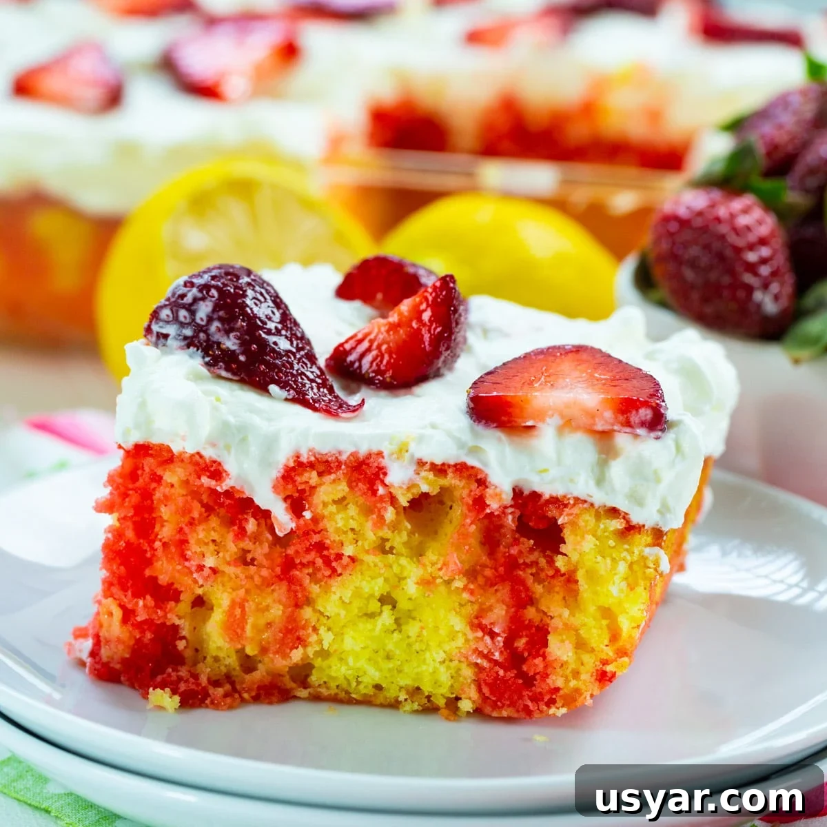 Refreshing Strawberry Lemonade Poke Cake 2 Slice of Strawberry Lemonade Poke Cake on plate.
