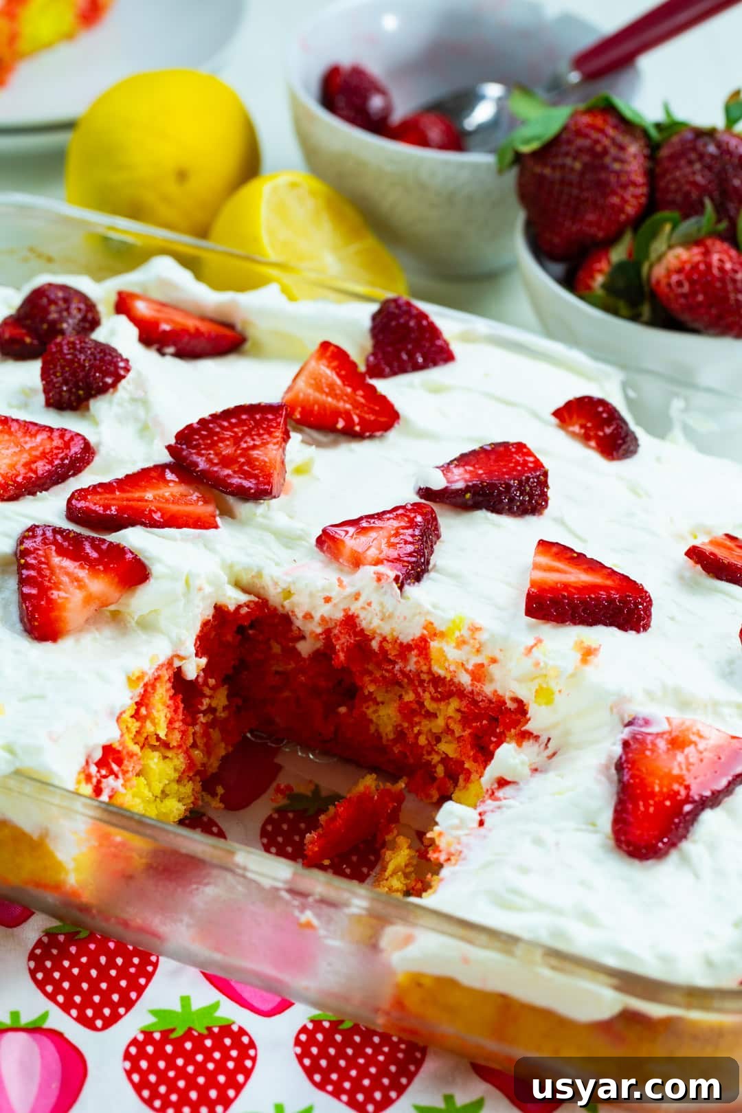 Refreshing Strawberry Lemonade Poke Cake 7 Strawberry Lemonade Poke Cake with slice removed.