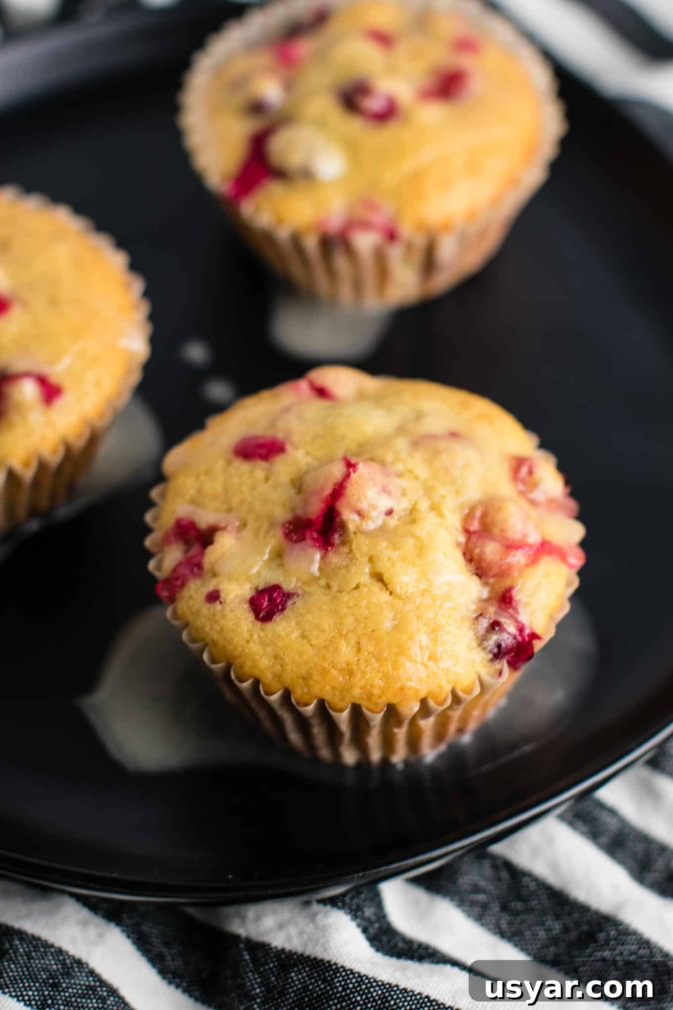 Healthy Cranberry Orange Muffins recipe made with greek yogurt and whole wheat pastry flour with a sweet orange glze. A healthier holiday breakfast or dessert! #breakfast #cranberry #muffins #cranberryorangemuffins #healthy