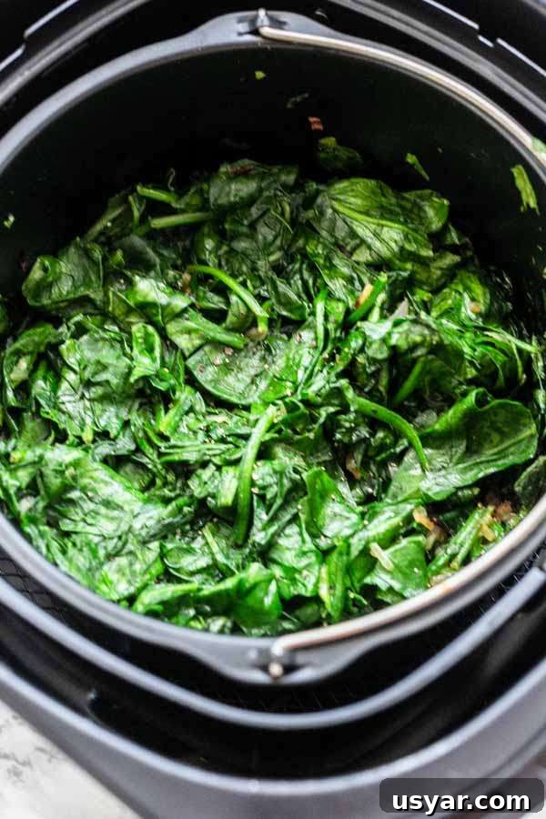 Crispy Garlic Air Fryer Spinach 9 Spinach made in an Air Fryer using fresh spinach. No butter needed for this recipe. Use a lid or aluminum to prevent the spinach from turing into spinach chips.