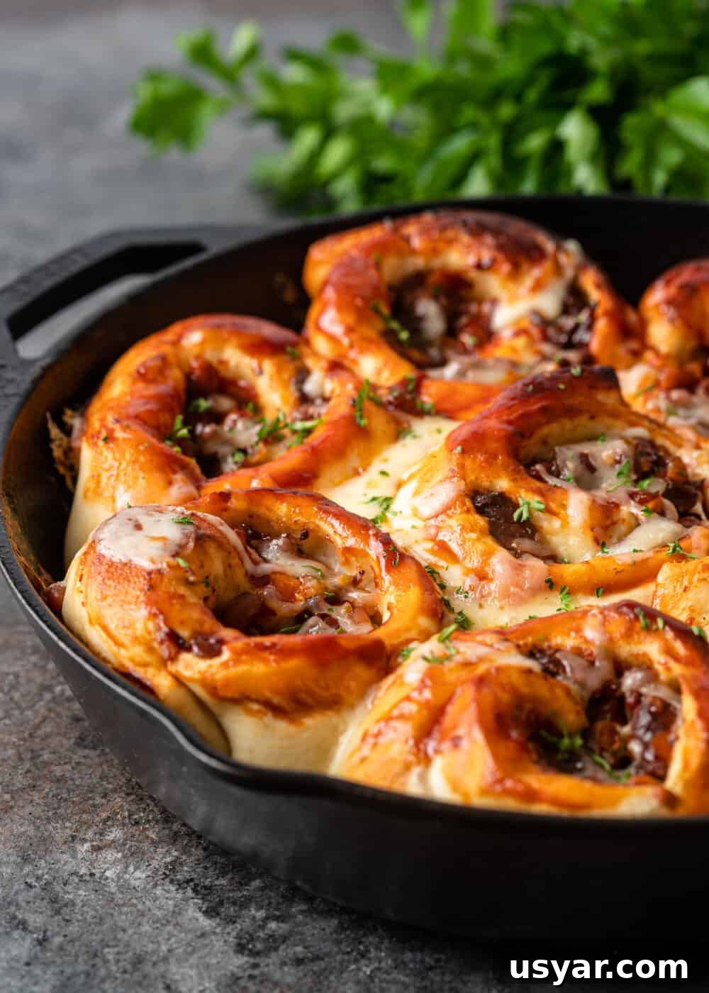 side view of bbq beef rolls in skillet